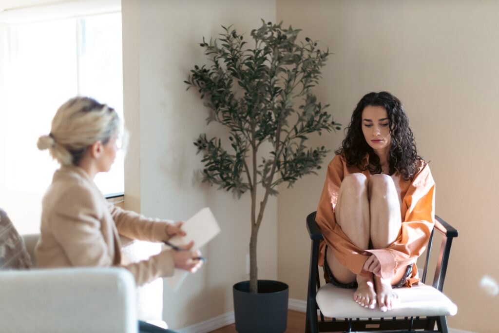 Woman feeling overwhelmed while speaking with a counsellor