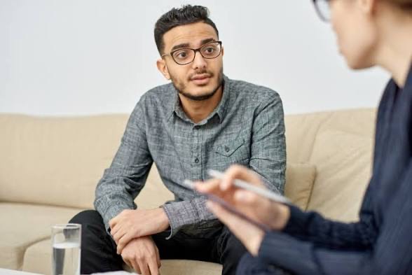 Adult man speaking with a counsellor during a one-to-one session
